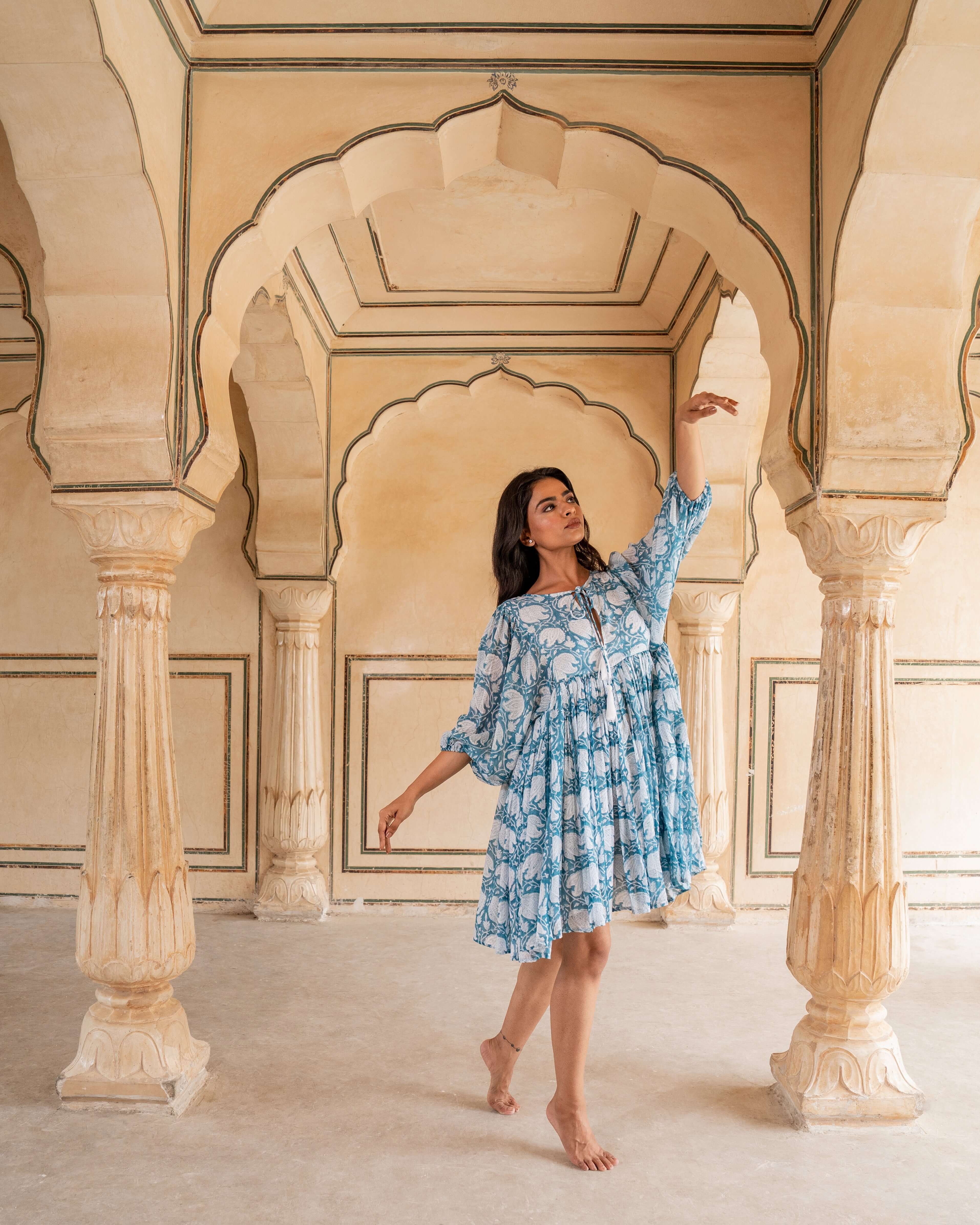 Floral-patterned blue cotton midi dress, designed for comfort with relaxed sleeves, flowy fit, and handy side pockets for effortless style.