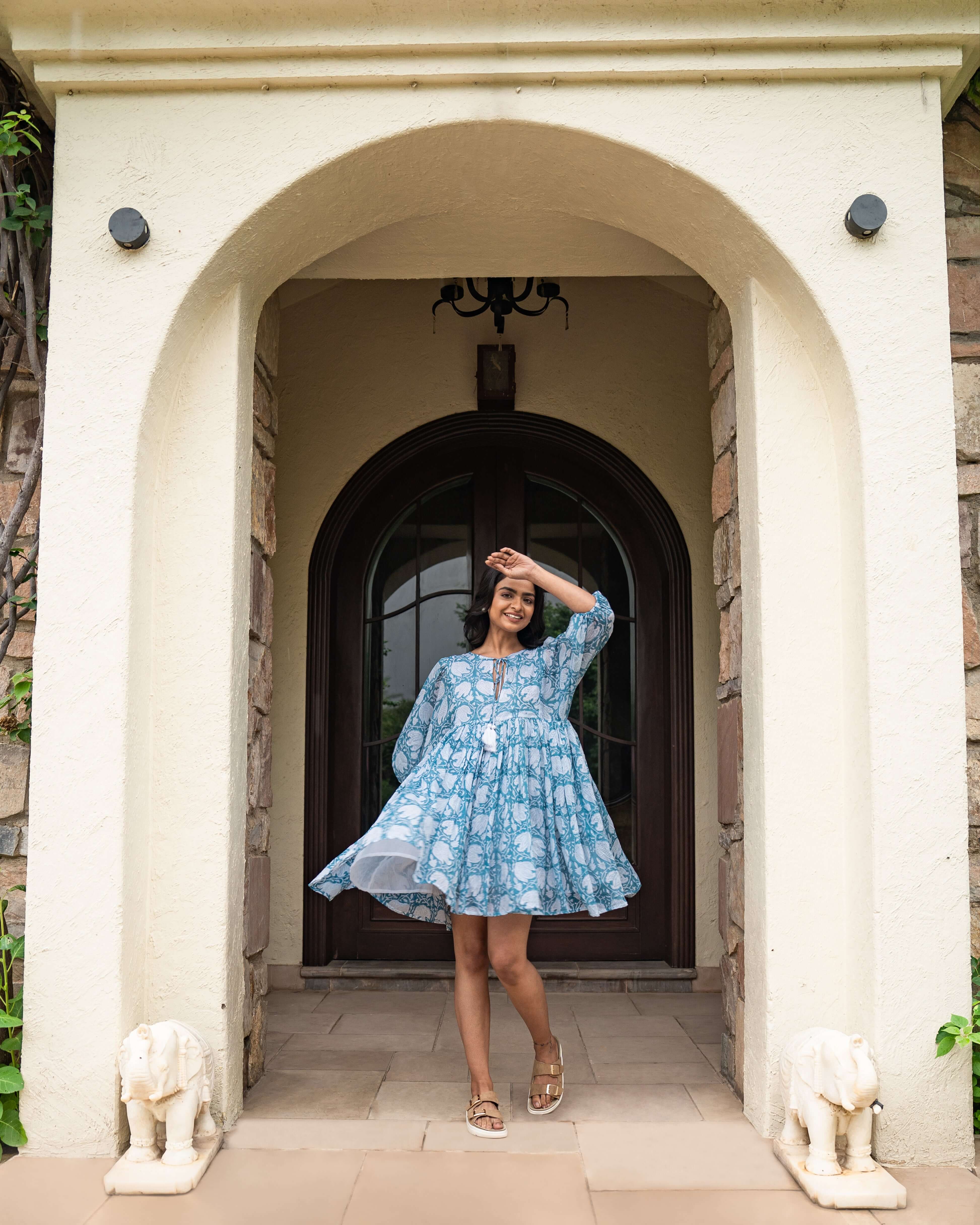 Beautifully handmade blue floral midi dress in soft cotton, featuring a flowy silhouette, relaxed sleeves, and front tie cord for a chic look.