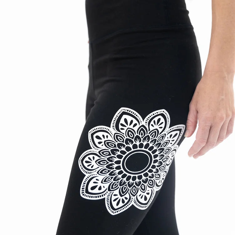Transform your fitness routine with full-length black yoga leggings with a unique mandala print. Stretch, move, and shine in style!