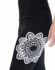 Transform your fitness routine with full-length black yoga leggings with a unique mandala print. Stretch, move, and shine in style!