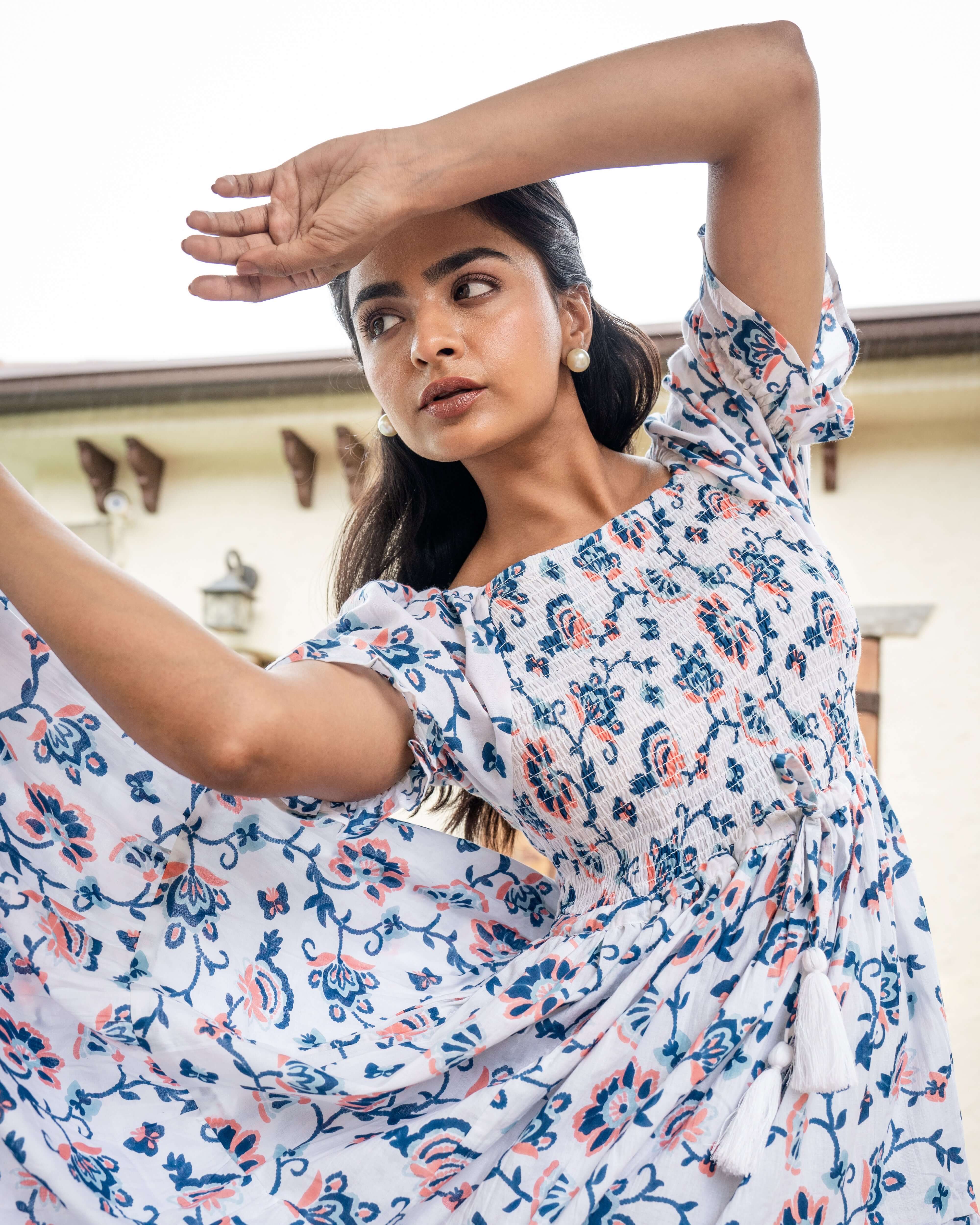 Artisanal blue and orange floral maxi dress with a shirred chest design, adjustable sleeves, and side pockets for a perfect blend of style and comfort.