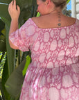 Chic pink floral cotton maxi dress with a flattering shirred top. Ideal for a stylish, breezy day look.