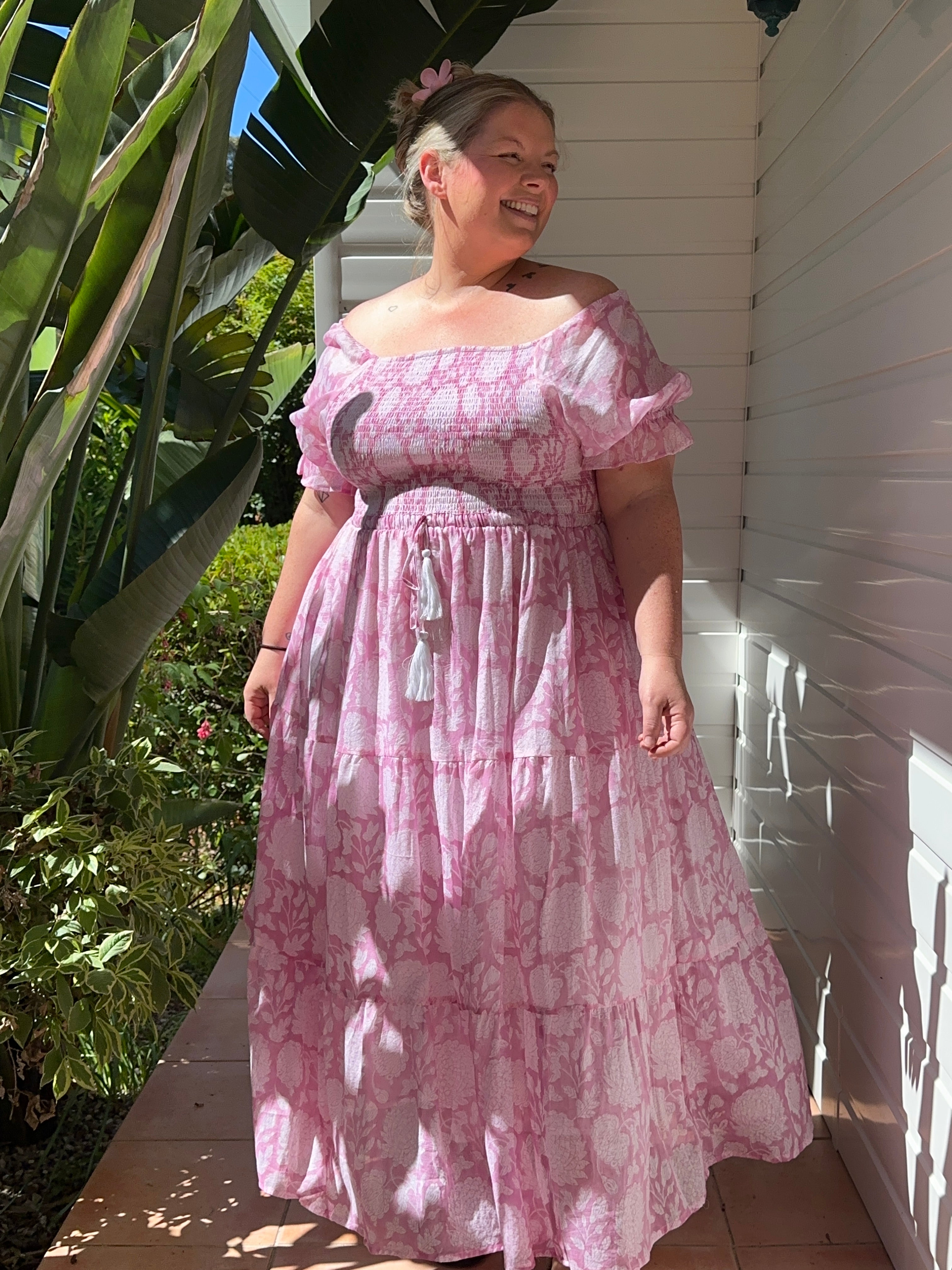 Flattering pink floral maxi dress with shirred top, crafted from soft cotton for effortless elegance and all-day comfort.