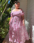 Flattering pink floral maxi dress with shirred top, crafted from soft cotton for effortless elegance and all-day comfort.