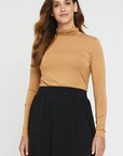 "Stylish beige bamboo women's top: Luxurious comfort meets sustainability in versatile clothing."