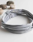 "Achieve effortless style with our organic twist headband in grounding gray. Comfort meets fashion. Buy now!"