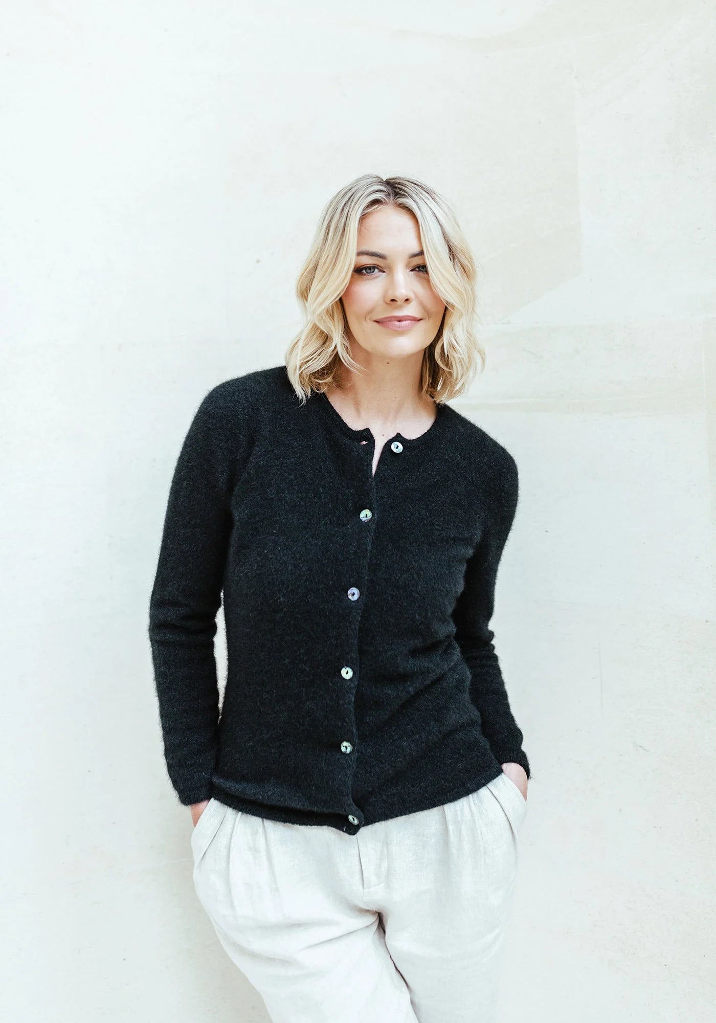 "Upgrade your look with our black merino wool button-up cardigan. Exceptional quality meets unbeatable style."
