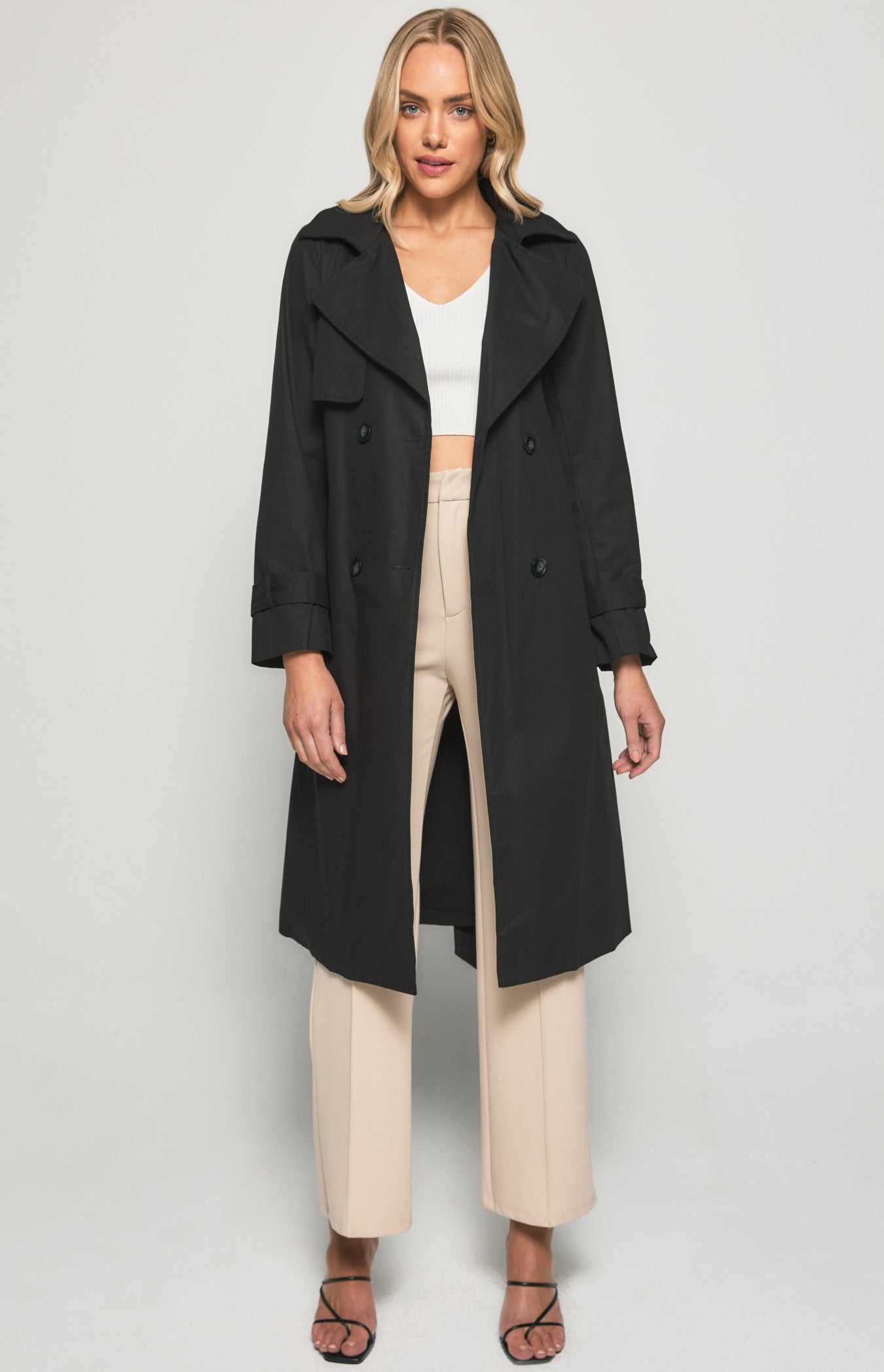 Embrace timeless elegance with our black trench coat. Perfectly tailored for any occasion. Enhance your wardrobe today