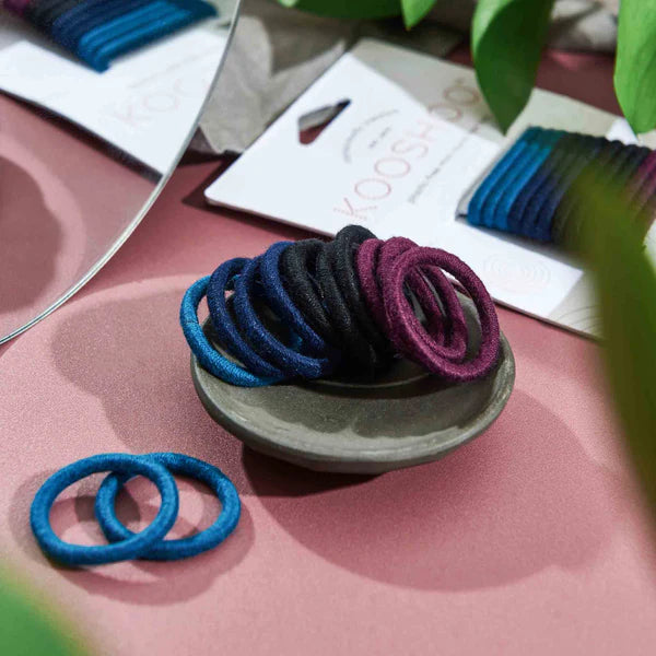 "Discover Kooshoo's plastic-free mini hair ties. Stylish, sustainable, and available in purple, black, and blue. Great for you and the planet!"