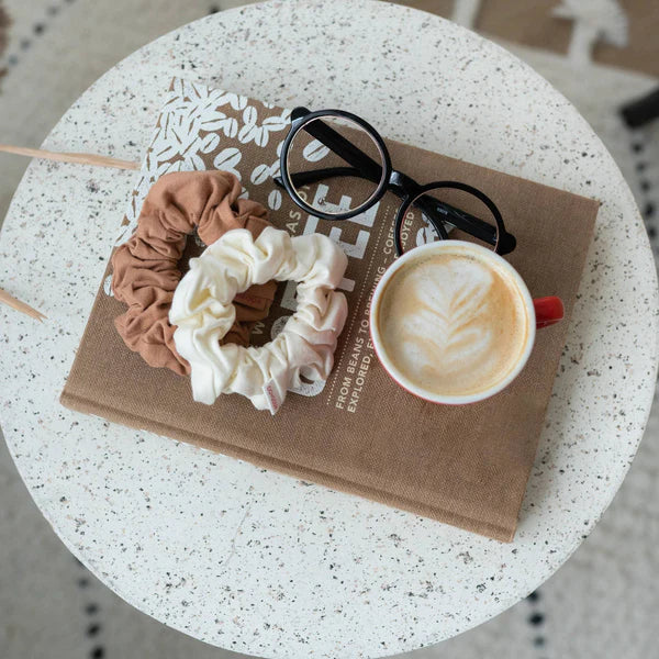 "Eco-friendly & stylish! Discover Kooshoo's plastic-free scrunchies in brown & beige. Perfect for any look, guilt-free. Shop now for sustainable hair accessories!"