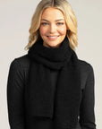 Complete your winter look with our black merino wool ribbed scarf. Luxurious warmth for any occasion.