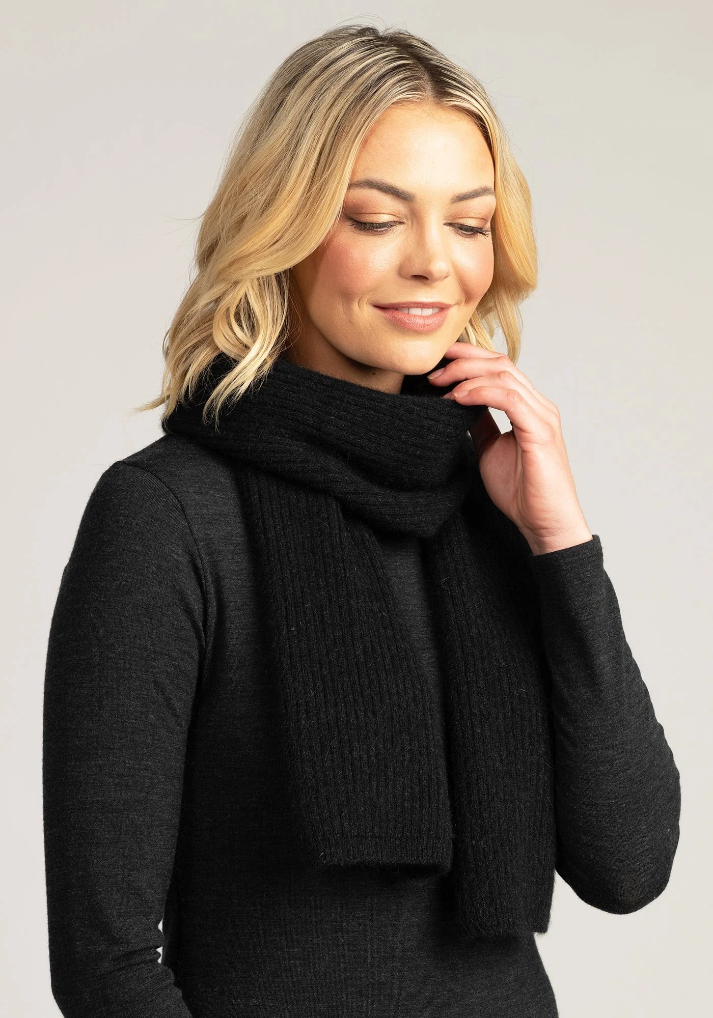 Wrap yourself in comfort and style with our black merino wool ribbed scarf. The ultimate cold-weather accessory!