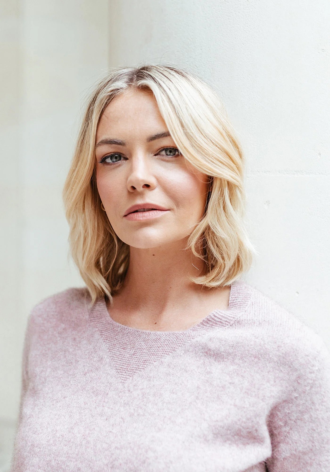 "Make a statement in soft pink. Our merino wool sweater adds warmth and charm to any outfit."