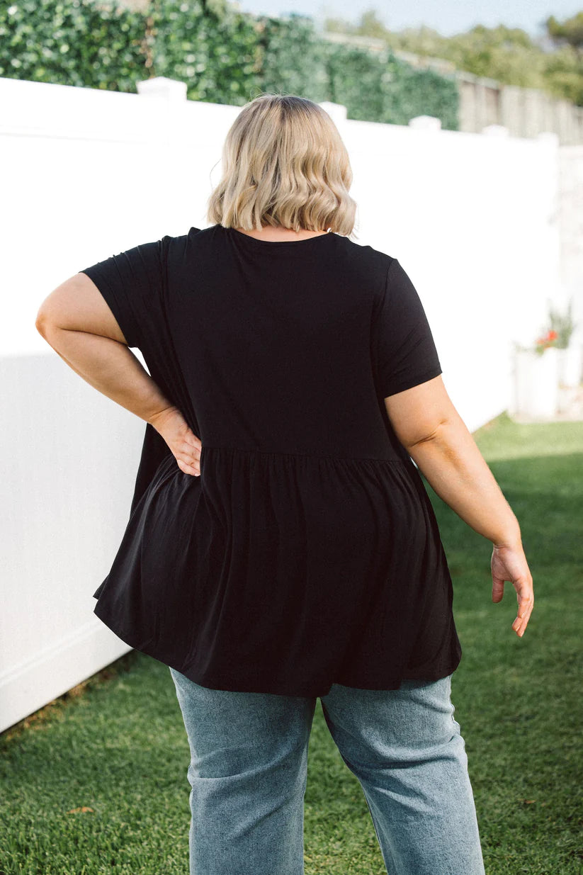 Effortlessly chic and versatile, our Plus-Size Wide Black Top is a wardrobe must-have. Featuring pockets for added convenience and style.
