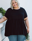 Discover the perfect blend of comfort and style in our Plus-Size Wide Black Top. With pockets for functionality, it's a must-have staple.
