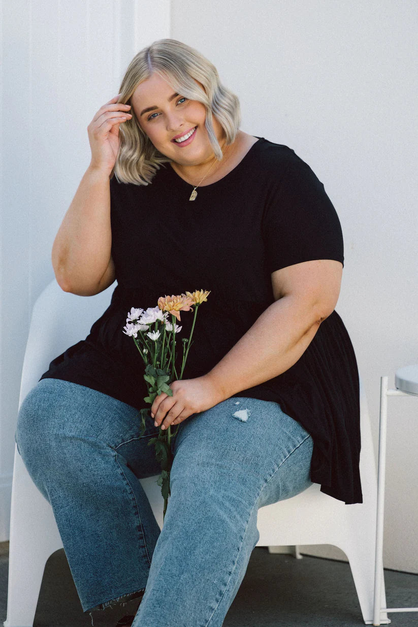 Elevate your style with our chic Plus-Size Wide Black Top! Featuring pockets for convenience and a flattering fit, it's a wardrobe essential.