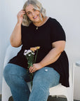 Elevate your style with our chic Plus-Size Wide Black Top! Featuring pockets for convenience and a flattering fit, it's a wardrobe essential.