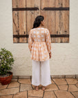 Stylish brown floral top with soft cotton fabric, adjustable cord, and relaxed silhouette, perfect for a casual yet elegant look.