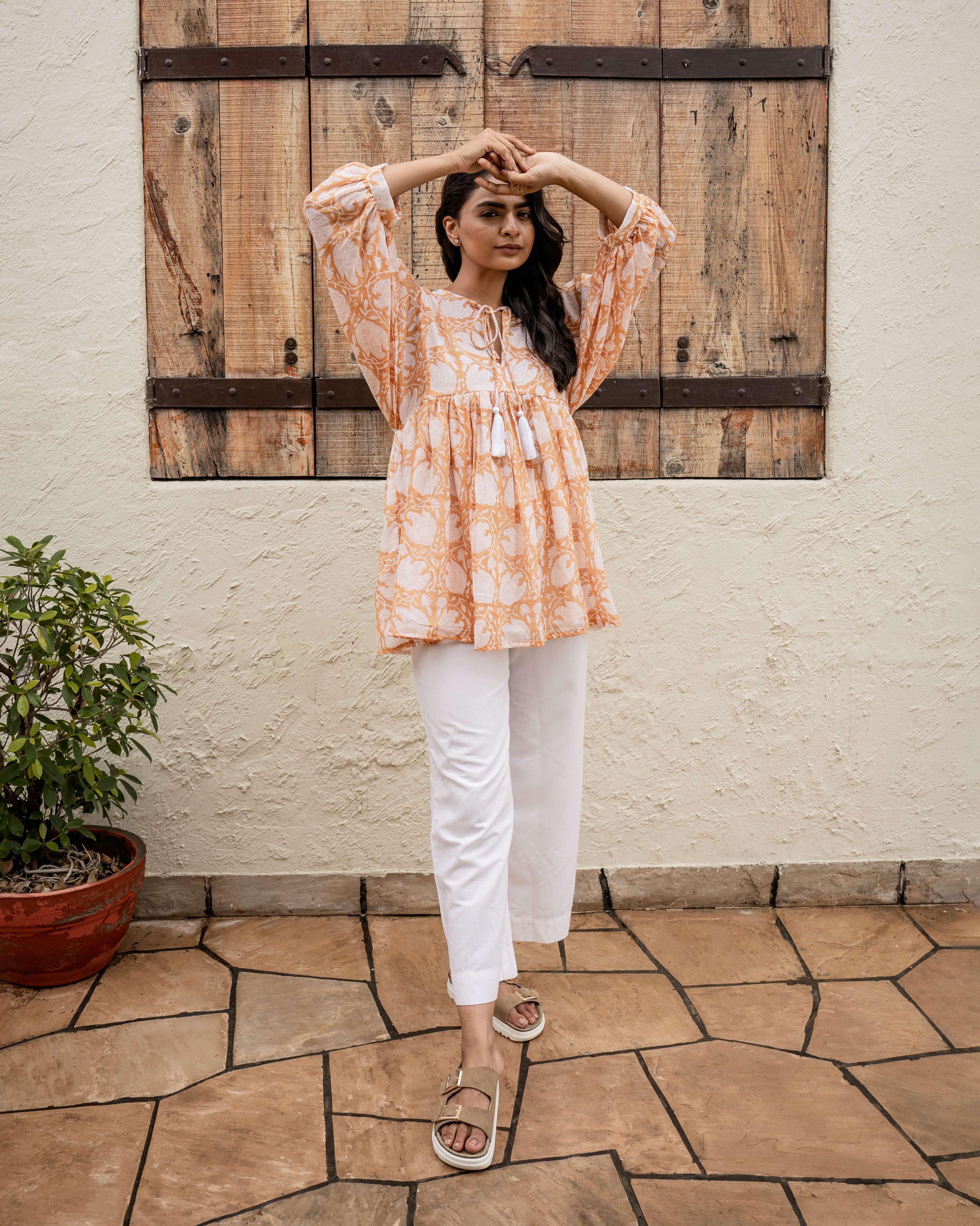 Beautiful caramel floral top crafted from 100% cotton with a relaxed fit, functional cord, and hand-block printed design for effortless elegance.