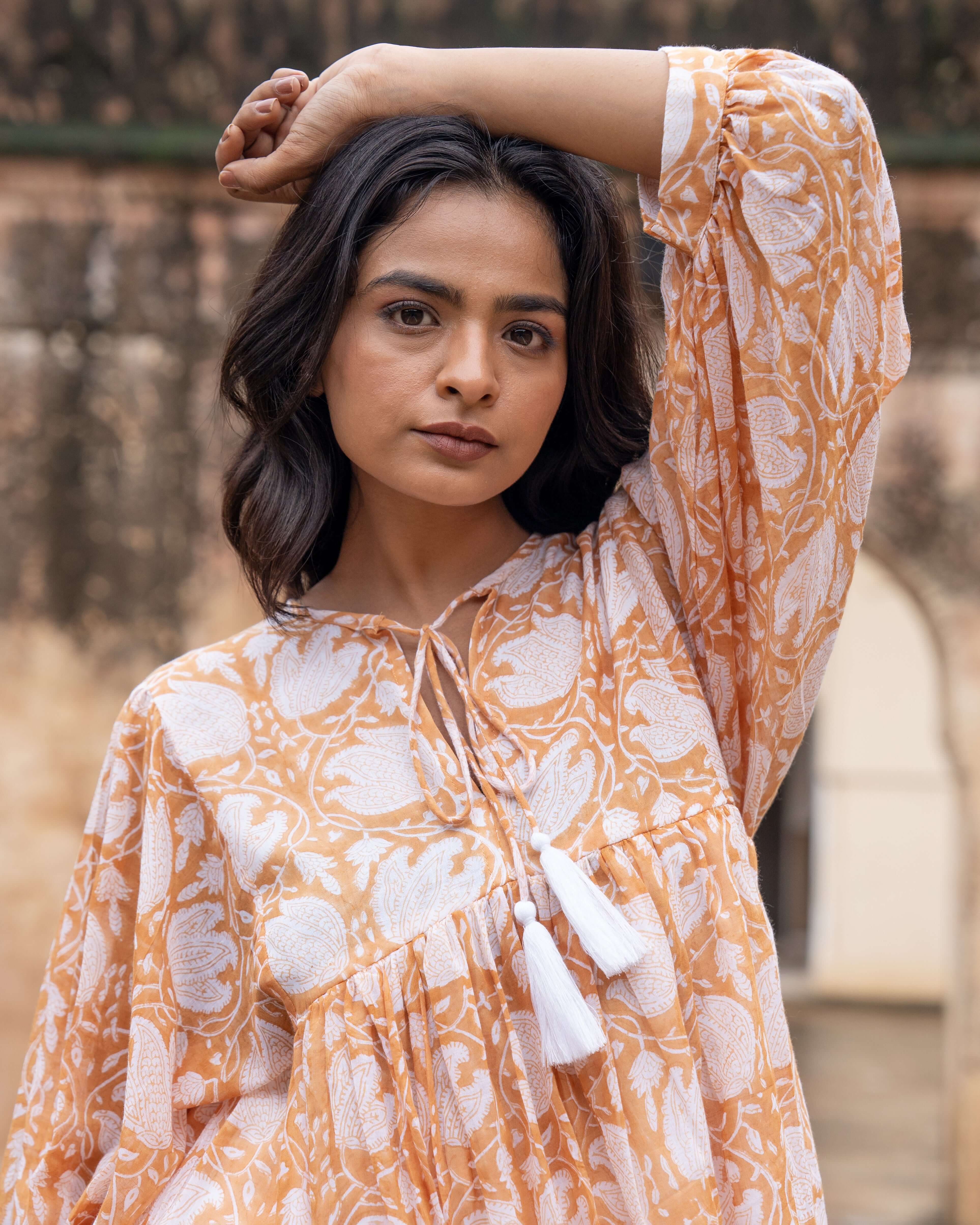 Handcrafted caramel floral top featuring vintage block print, adjustable cord, and relaxed silhouette, offering both elegance and comfort.