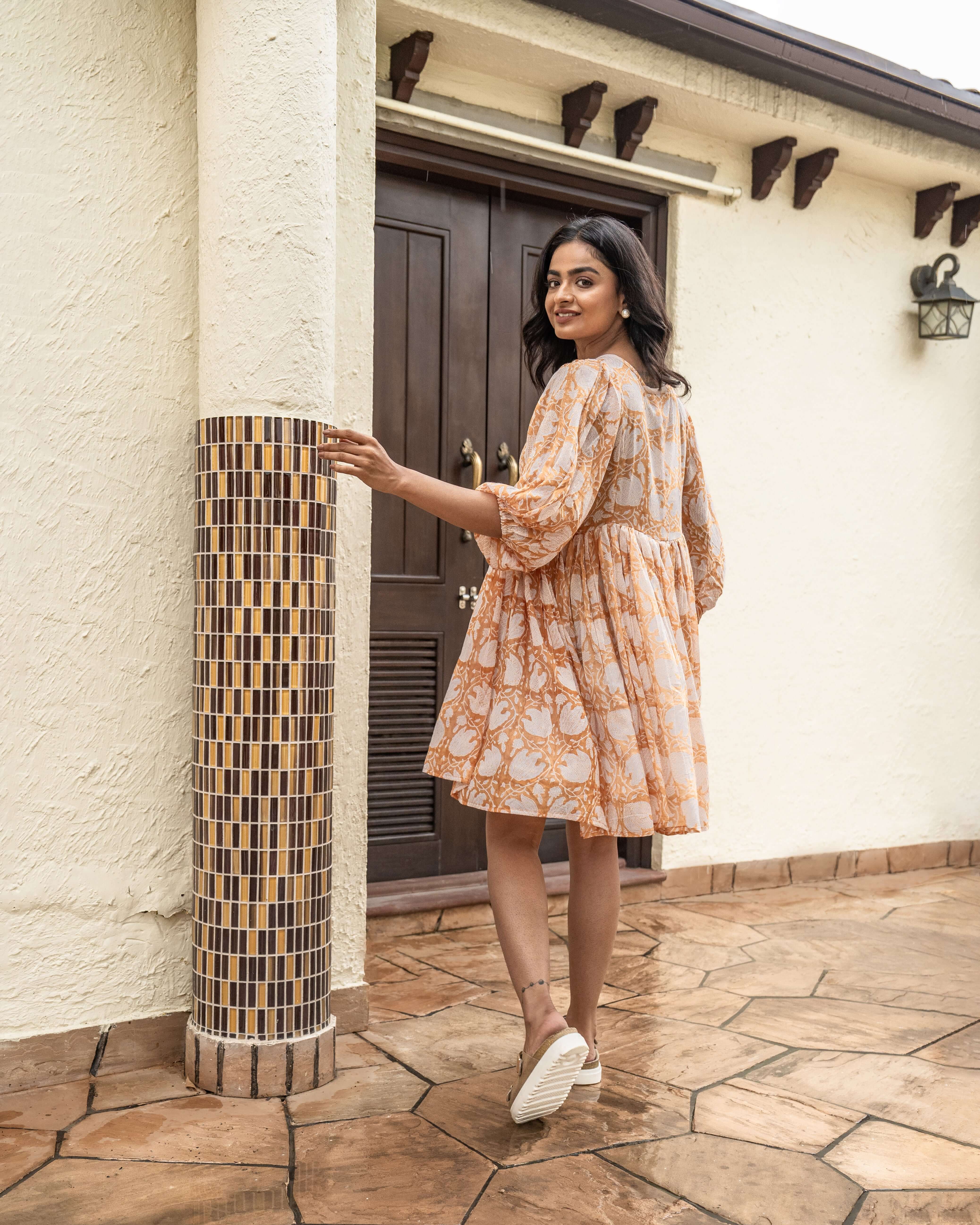 Elegant caramel midi dress with floral prints, crafted from breathable cotton for a stylish look that's perfect for any occasion.