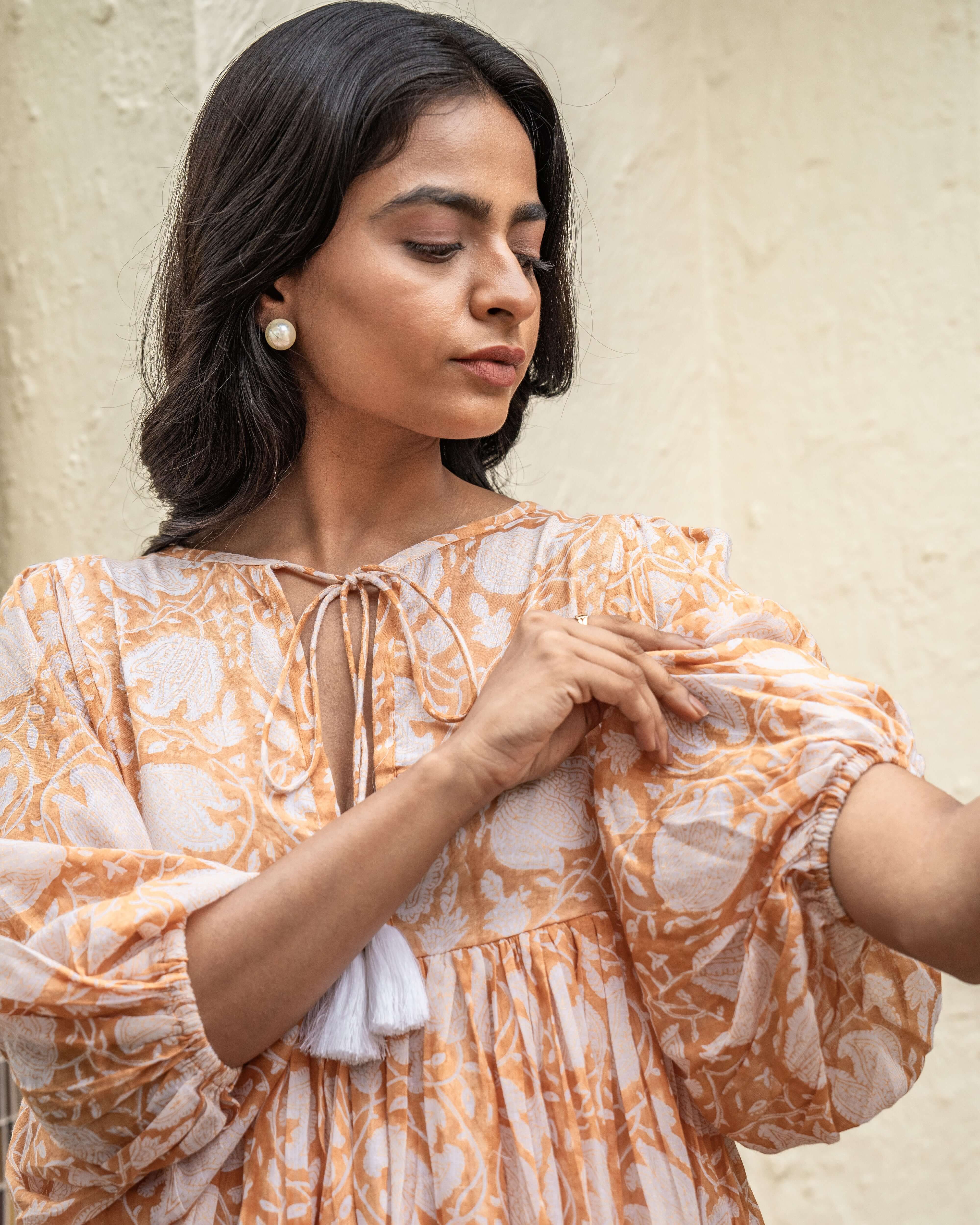 Chic caramel cotton midi dress featuring beautiful floral designs, perfect for day-to-night wear with a flattering and comfortable fit.