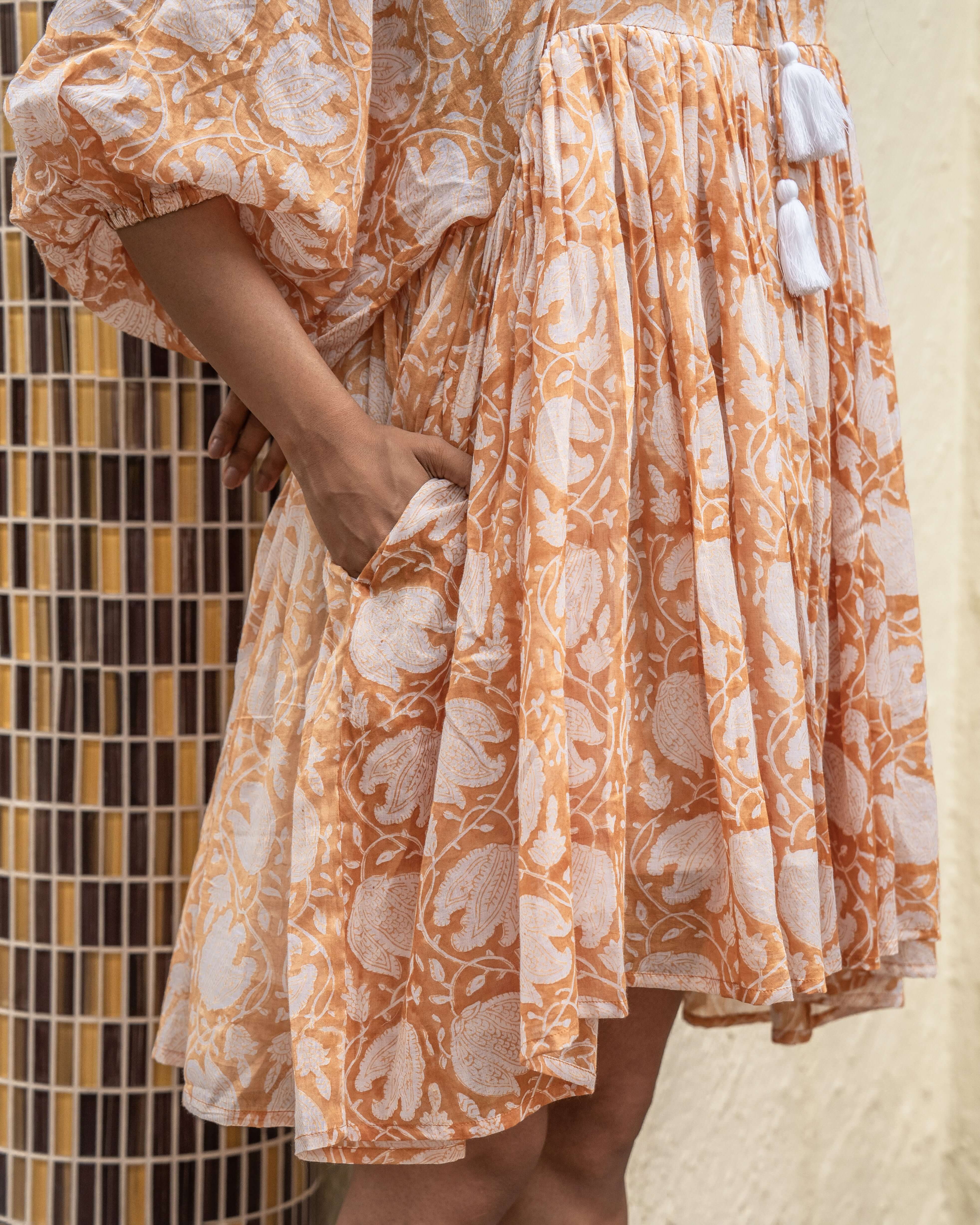 Floral-patterned caramel midi dress in soft cotton, ideal for sunny days or brunch outings, offering comfort and chic style effortlessly.