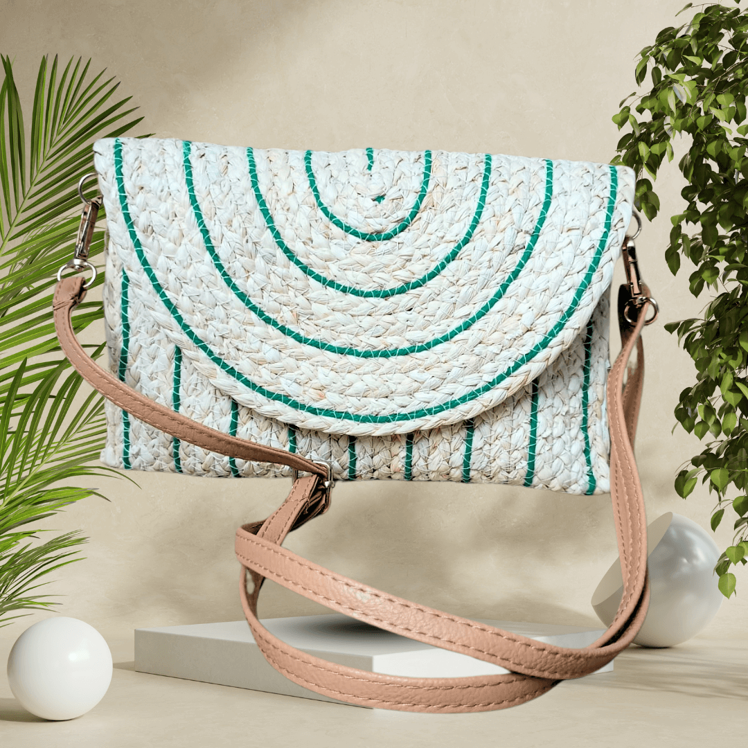 Eco-conscious straw clutch with a detachable strap and secure magnetic closure, featuring a vibrant woven design for everyday chic.