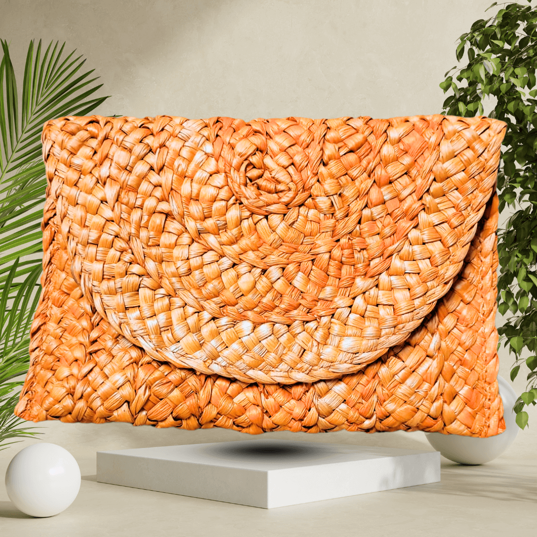 Vibrant orange handmade straw clutch bag, expertly crafted for a bold, eye-catching accessory that adds a pop of color to any outfit.