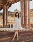 Hand block-printed sunflower midi dress on white, crafted from 100% cotton with long sleeves and side pockets for a comfortable, stylish fit.