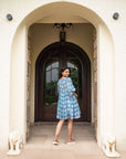 Handcrafted blue cotton midi dress with floral prints, relaxed sleeves, and a flattering silhouette, perfect for casual outings or special events.