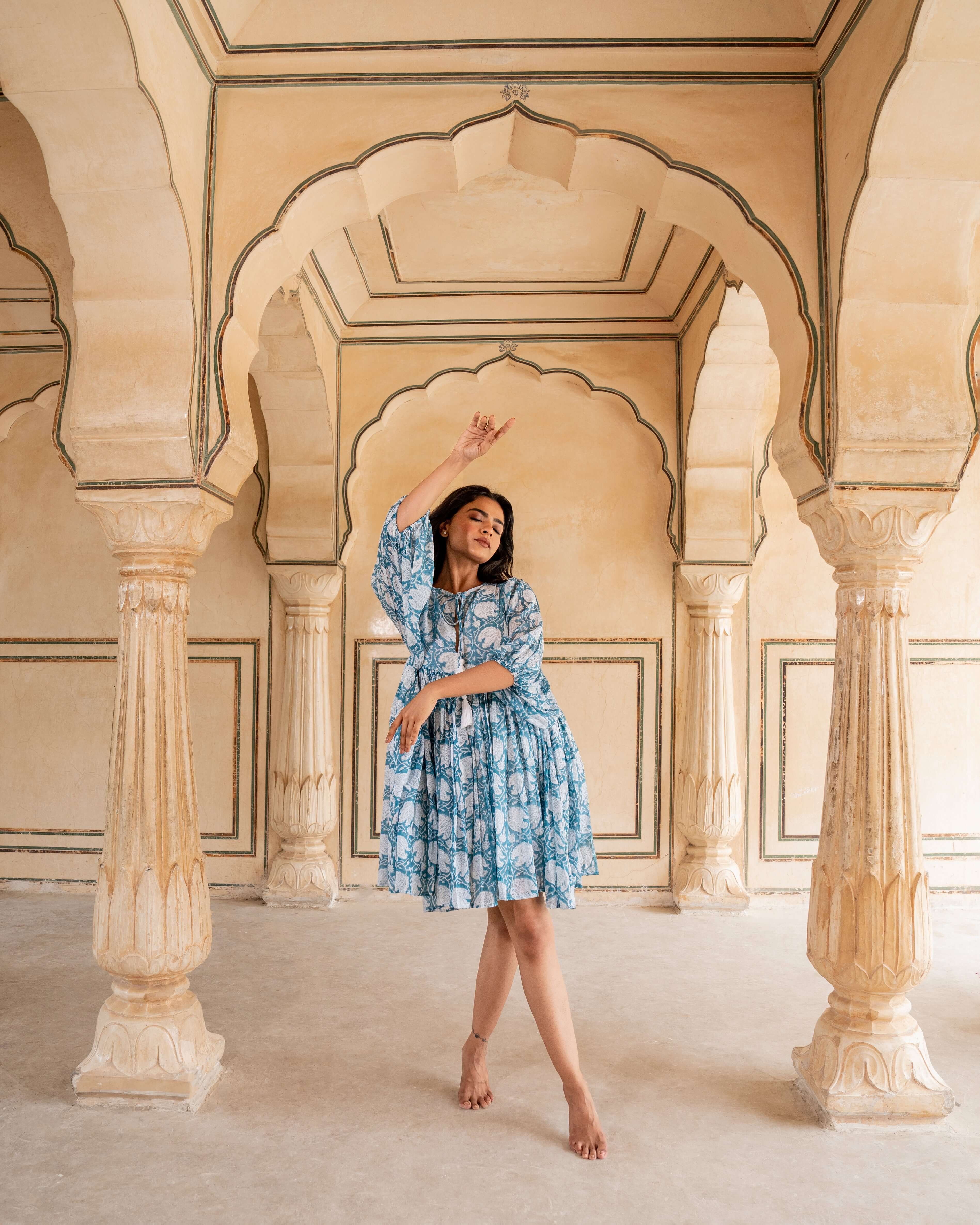 Blue cotton midi dress with exquisite floral block prints, featuring a flattering silhouette, relaxed sleeves, and practical side pockets.