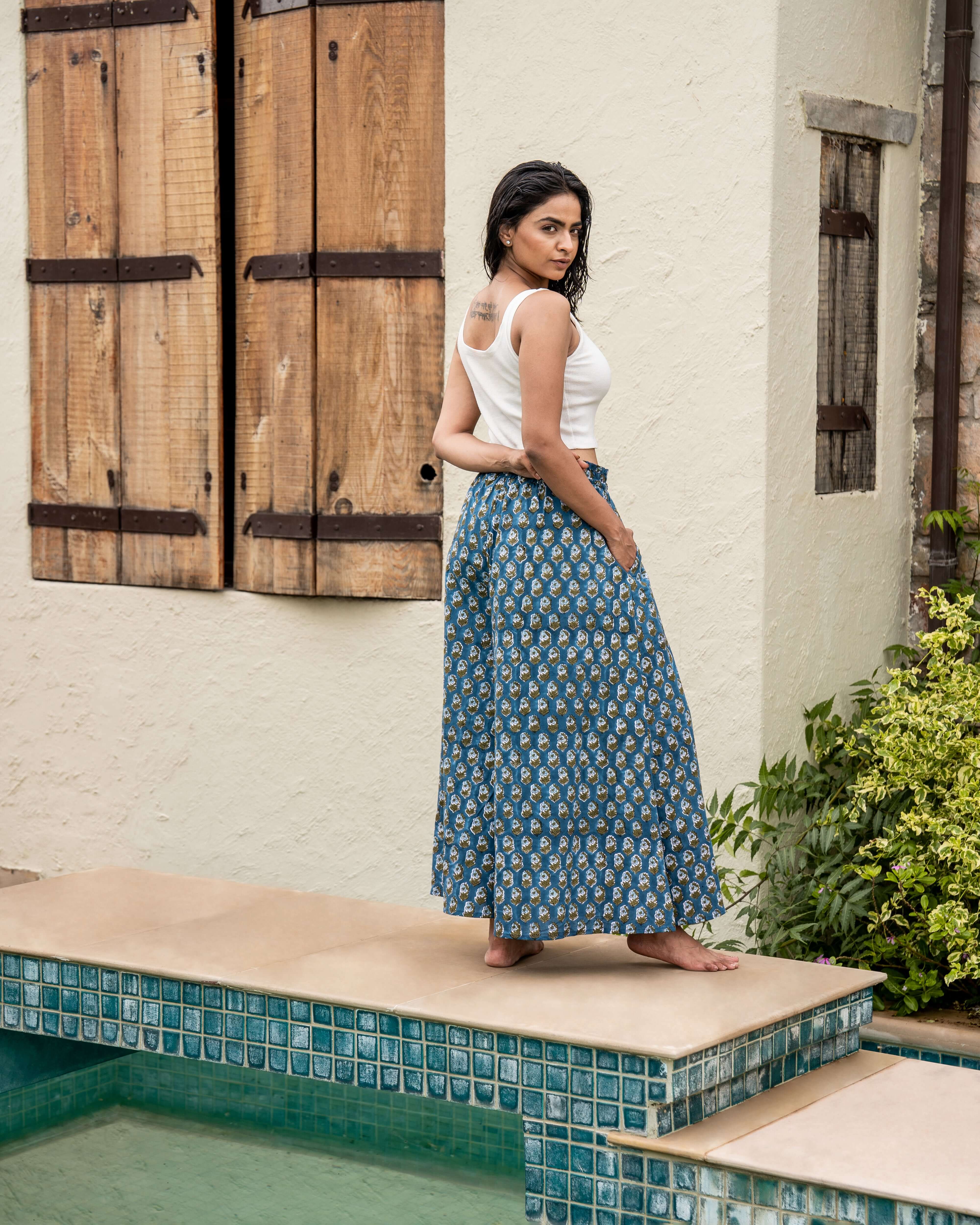 Elegant blue floral wide leg pants with a relaxed fit, elastic waist, and graceful flared legs, perfect for adding a touch of style to any outfit.