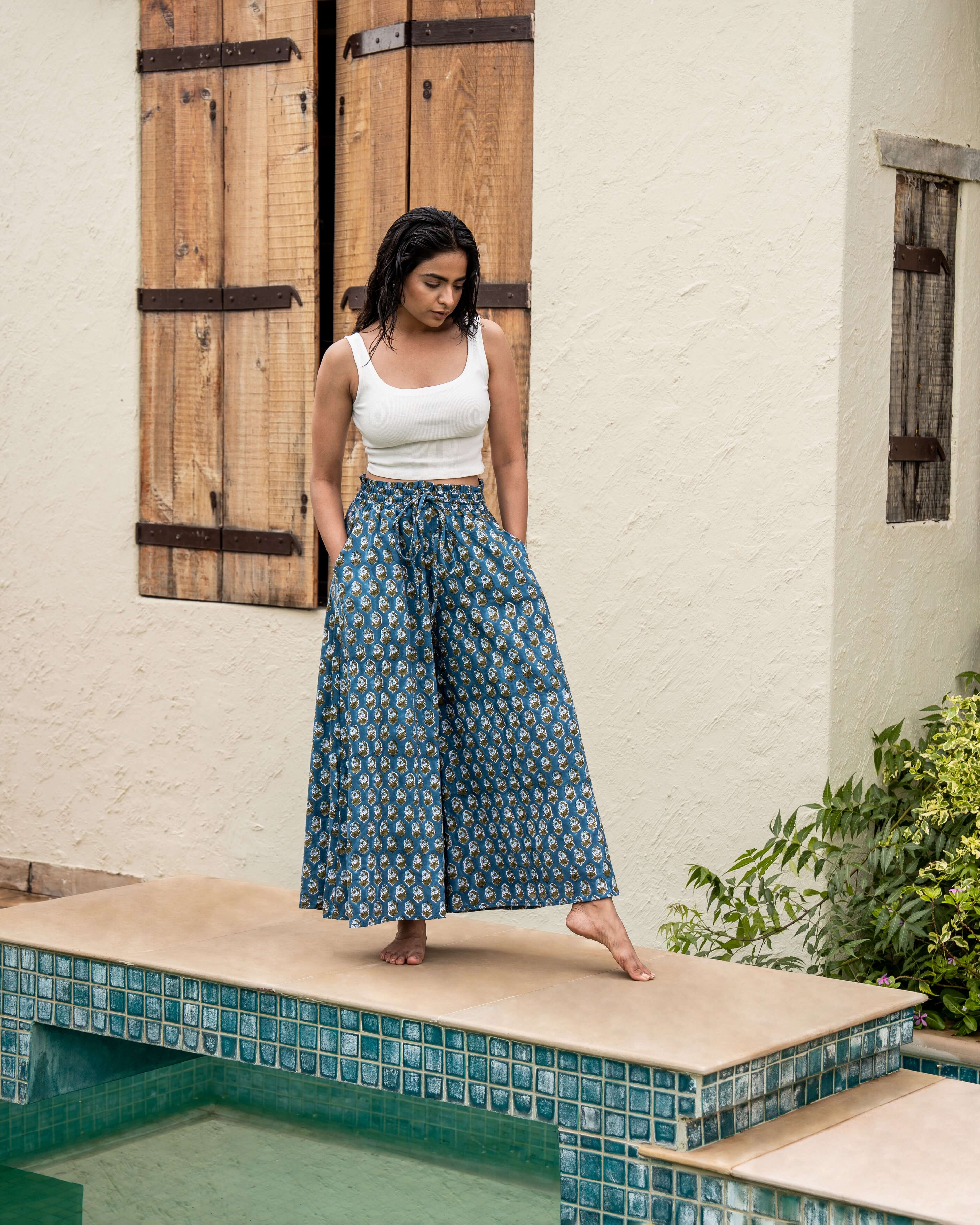 Timeless blue floral wide leg pants featuring flared legs and practical pockets, crafted by skilled artisans for a blend of style and functionality.