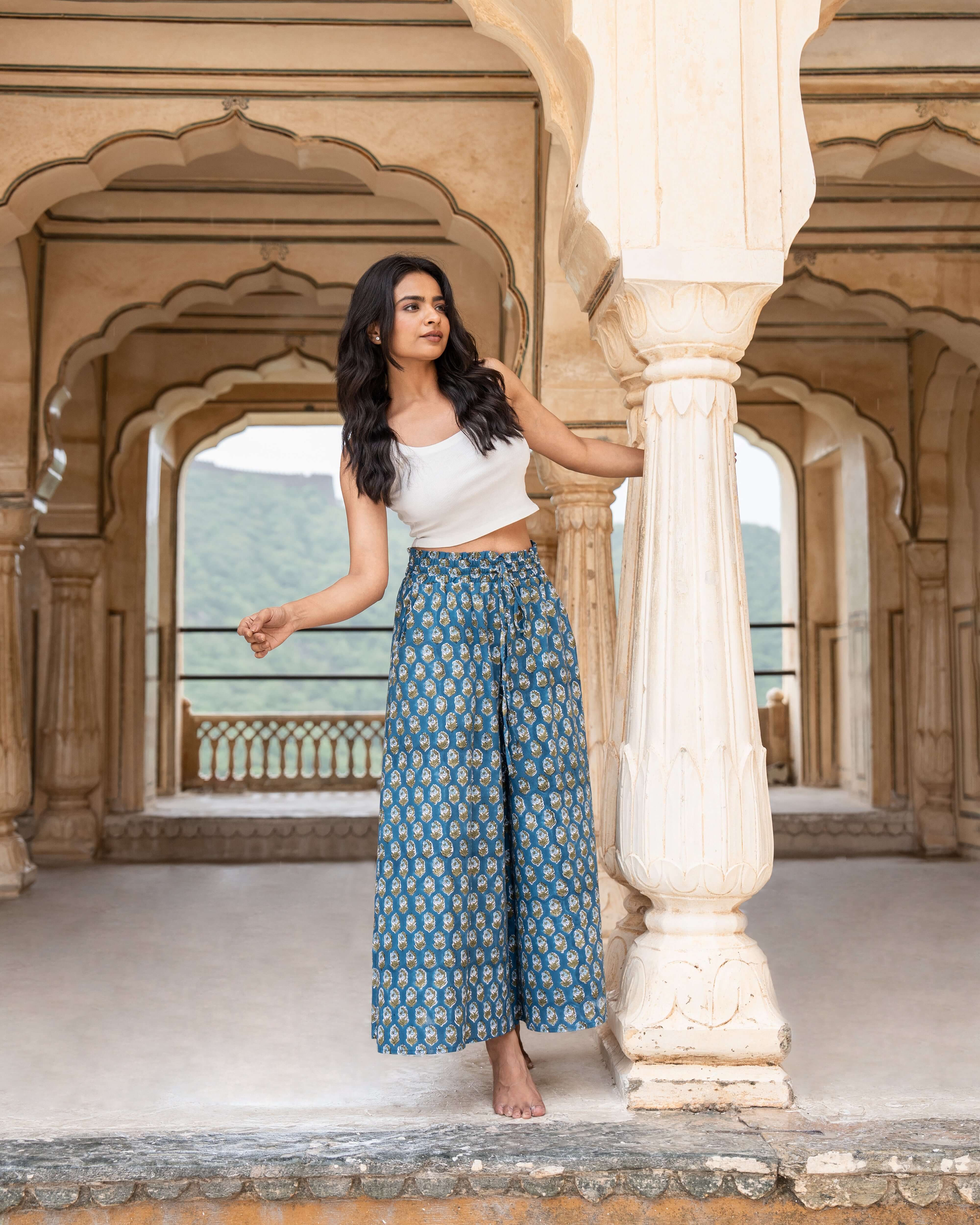 Beautiful indigo floral wide leg pants with a comfortable fit, featuring an adjustable elastic waist and flared legs for a stylish, modern look.