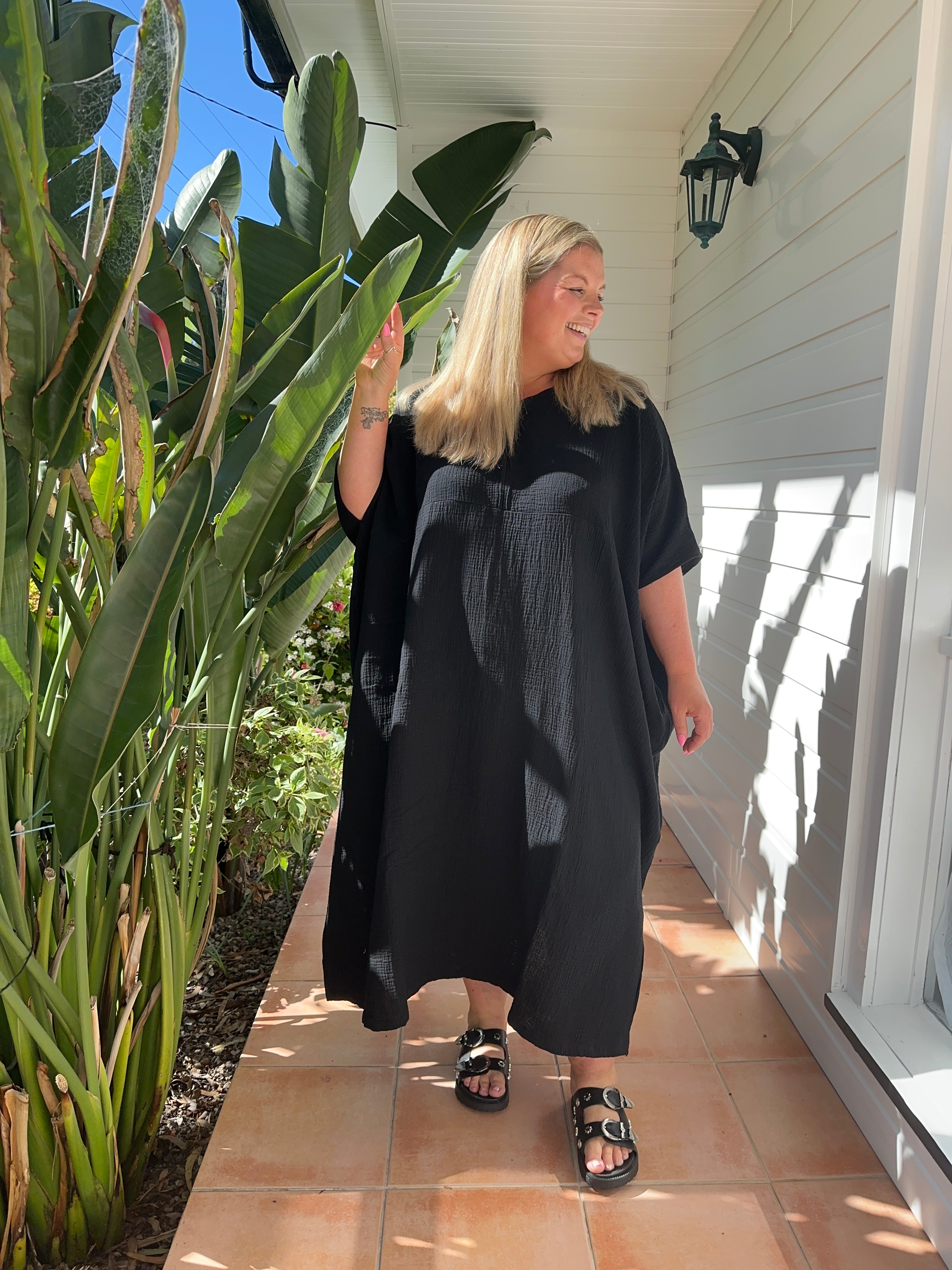 Black cotton gauze kaftan featuring a lightweight, full-length design, perfect for casual or beachwear.