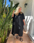 Black cotton gauze kaftan featuring a lightweight, full-length design, perfect for casual or beachwear.