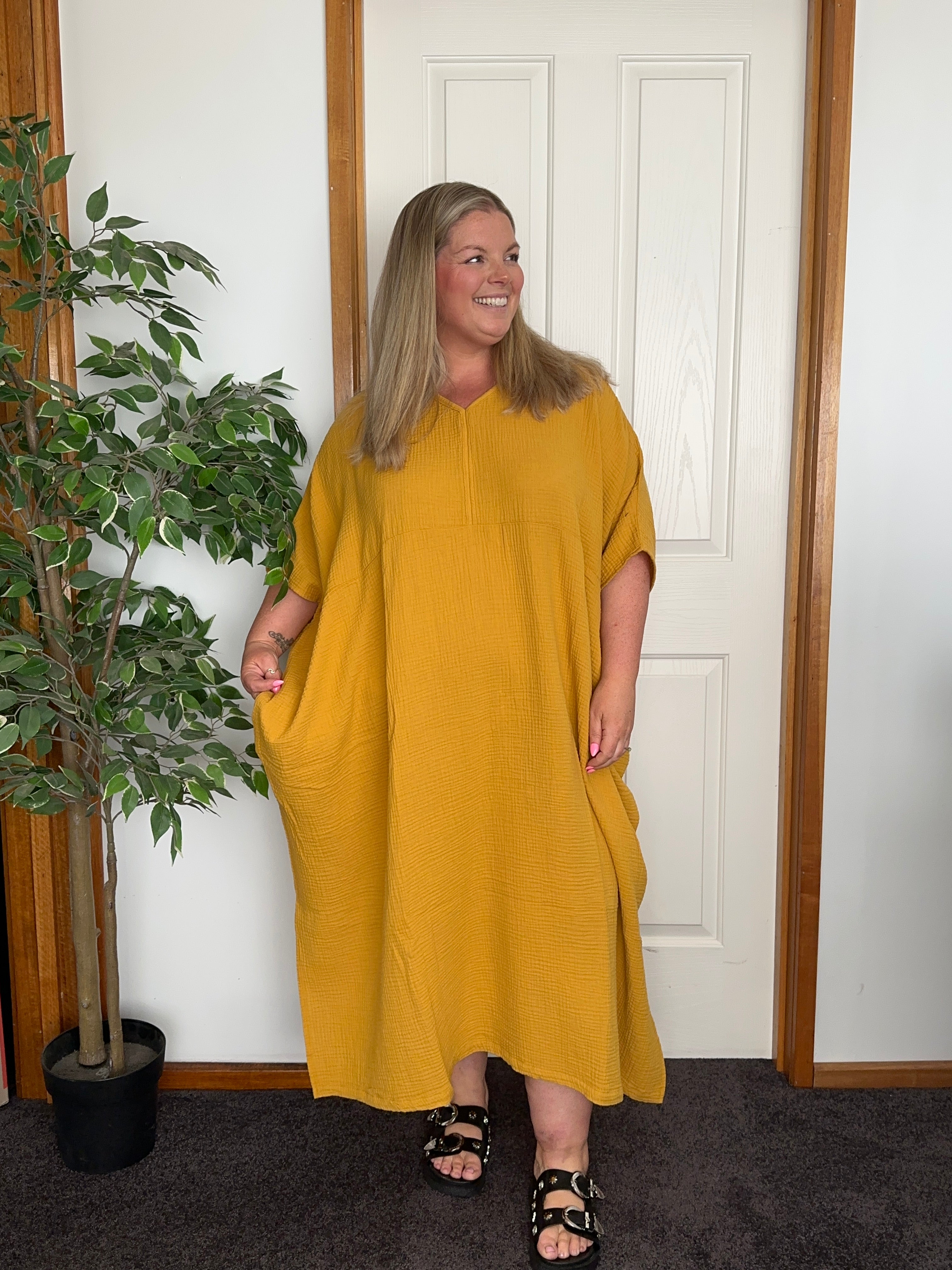 Elegant cotton gauze kaftan in mustard with a loose, full-length silhouette, ideal for warm-weather wear.