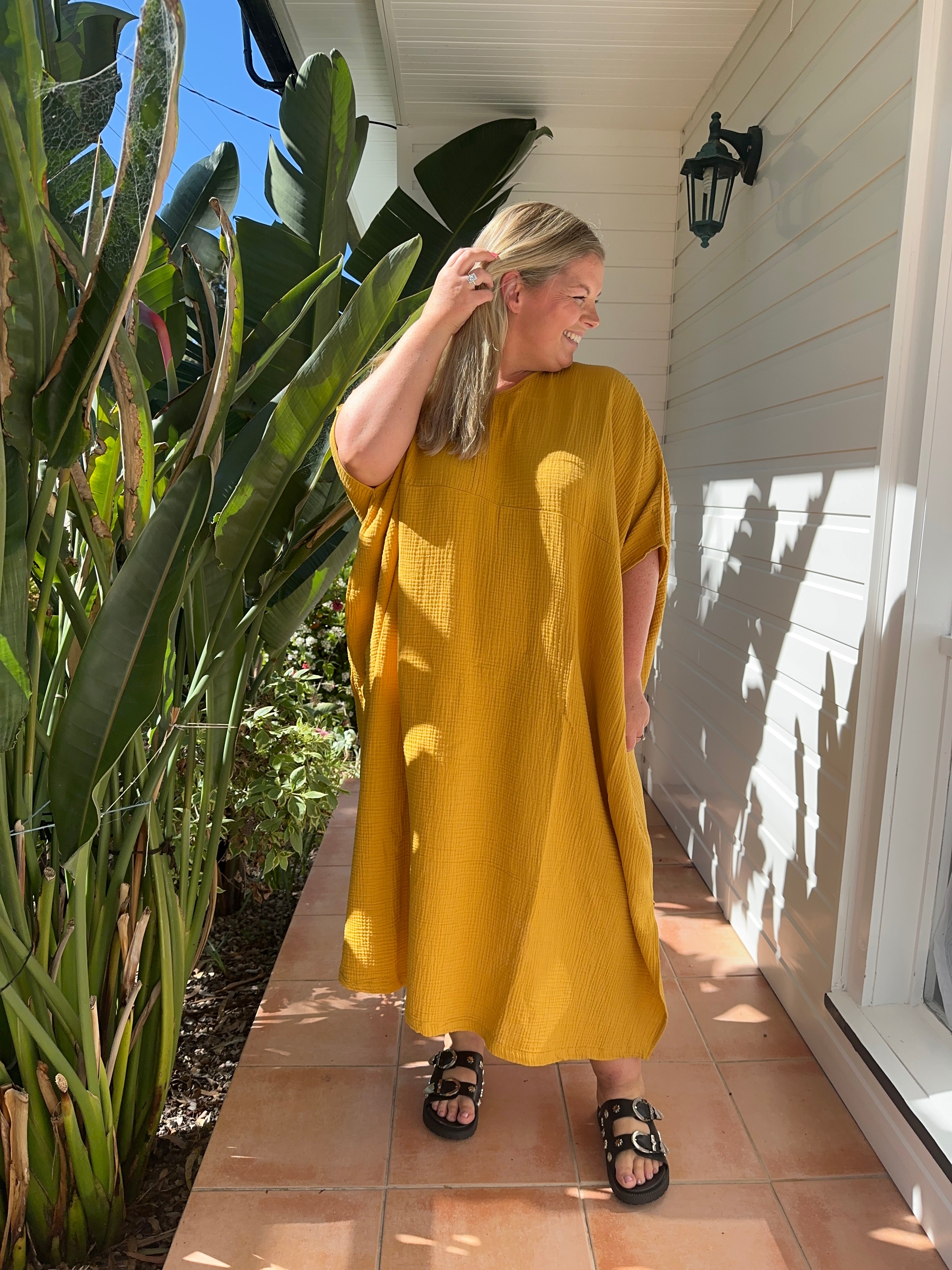 Mustard yellow long kaftan made of lightweight cotton gauze, offering a comfortable and stylish design.