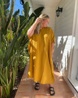 Mustard yellow long kaftan made of lightweight cotton gauze, offering a comfortable and stylish design.