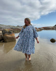 Light blue cotton midi dress with a relaxed fit and flowing skirt, perfect for casual wear.