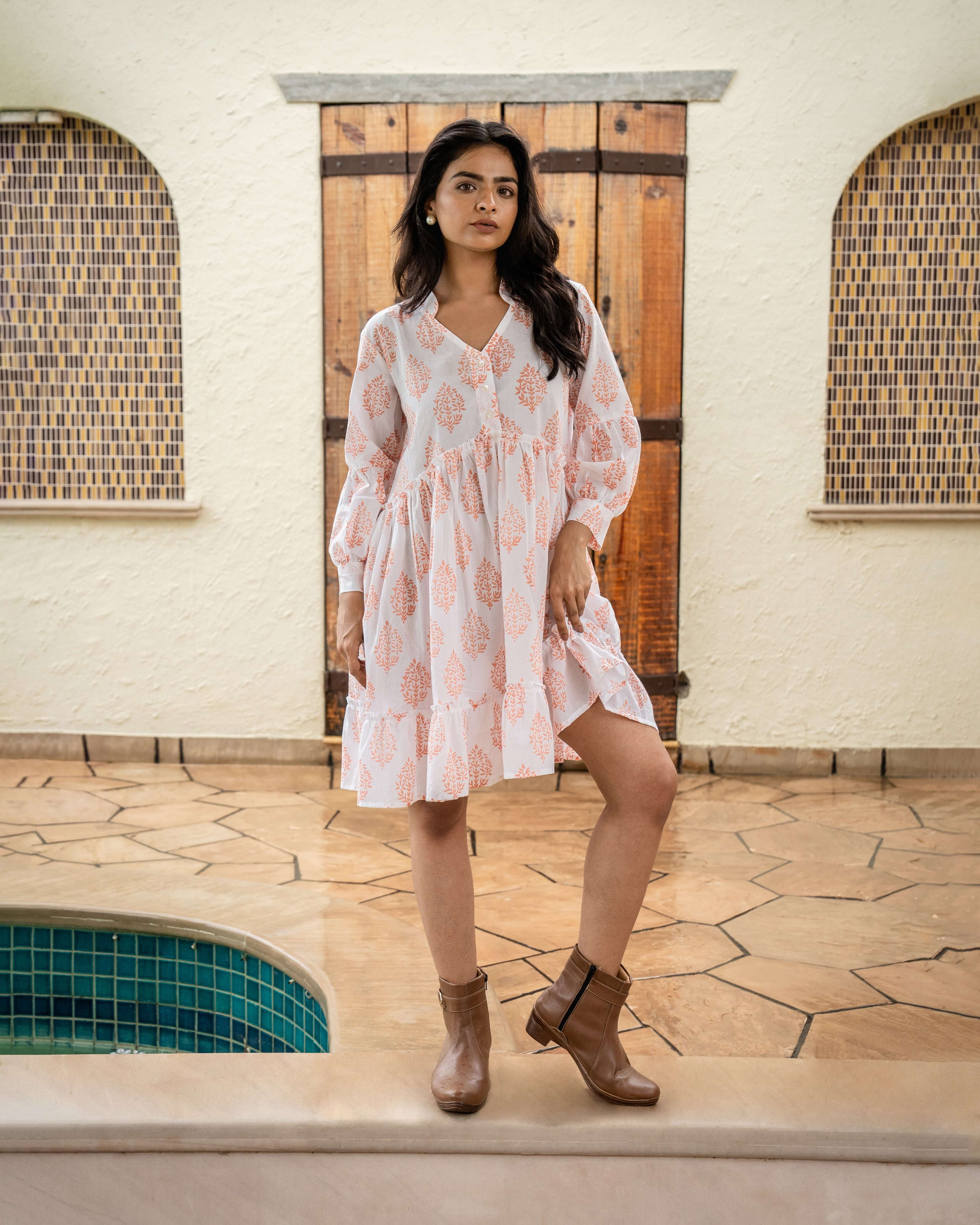 Stunning terracotta bloom midi dress in soft cotton, designed with long sleeves, a flowy silhouette, and handy side pockets for chic versatility.