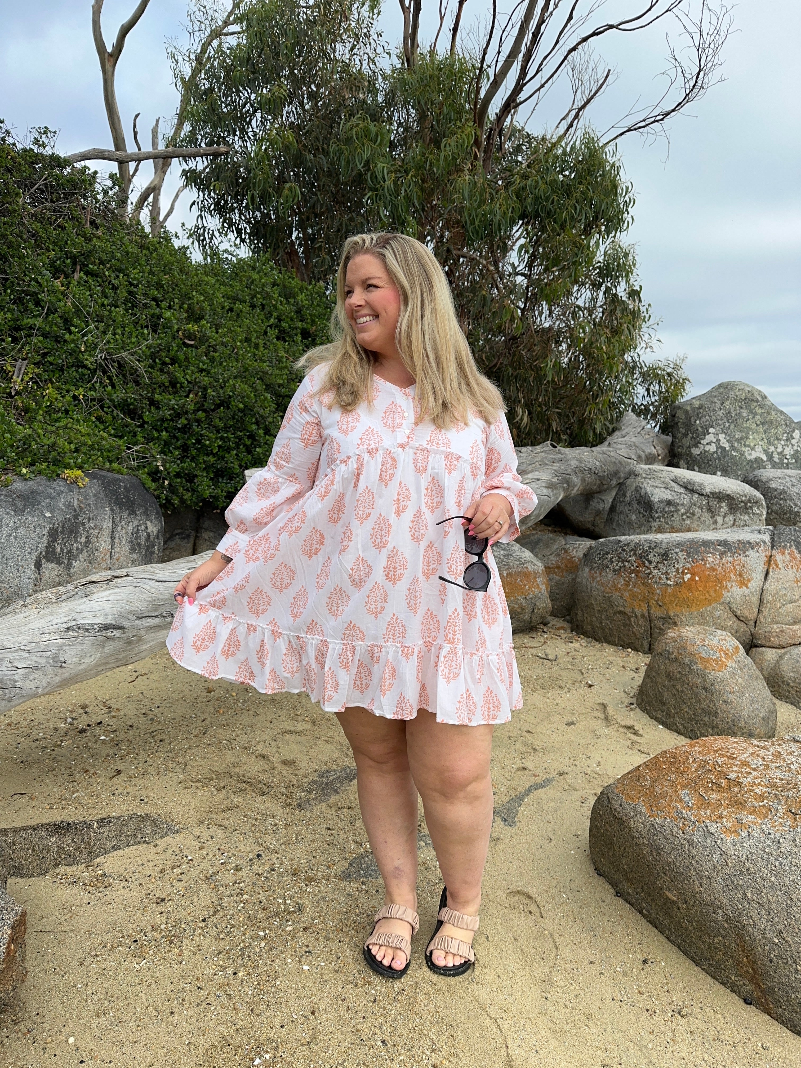 Beautiful floral cotton midi dress with a cinched waist and flowing skirt, perfect for spring and summer occasions.