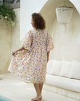 "Pincushion bloom midi dress: Elevate your style with this elegant and flattering cotton attire for any occasion."