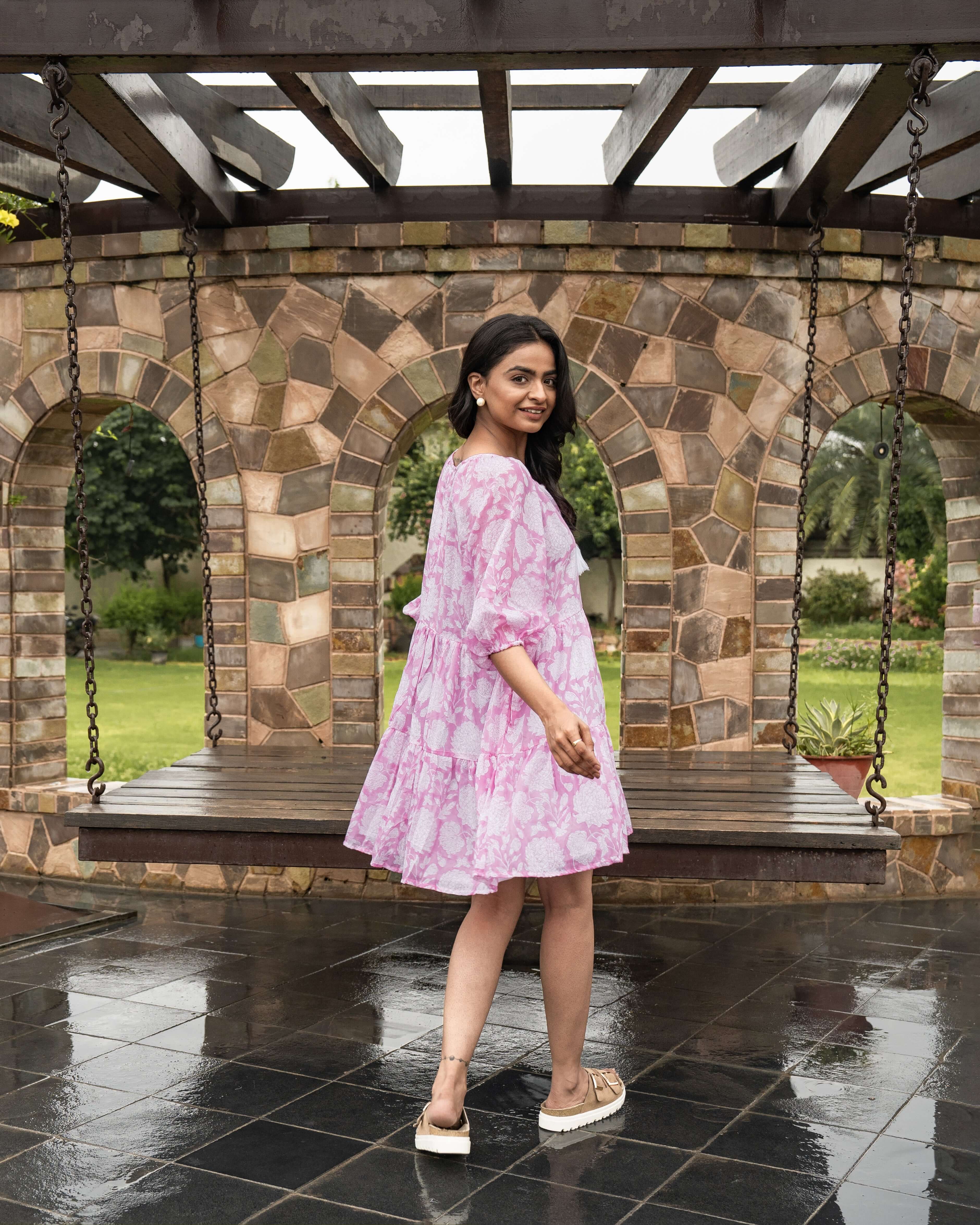 Stylish pink floral midi dress made from soft cotton, featuring a flattering silhouette, relaxed elastic sleeves, and handy side pockets.