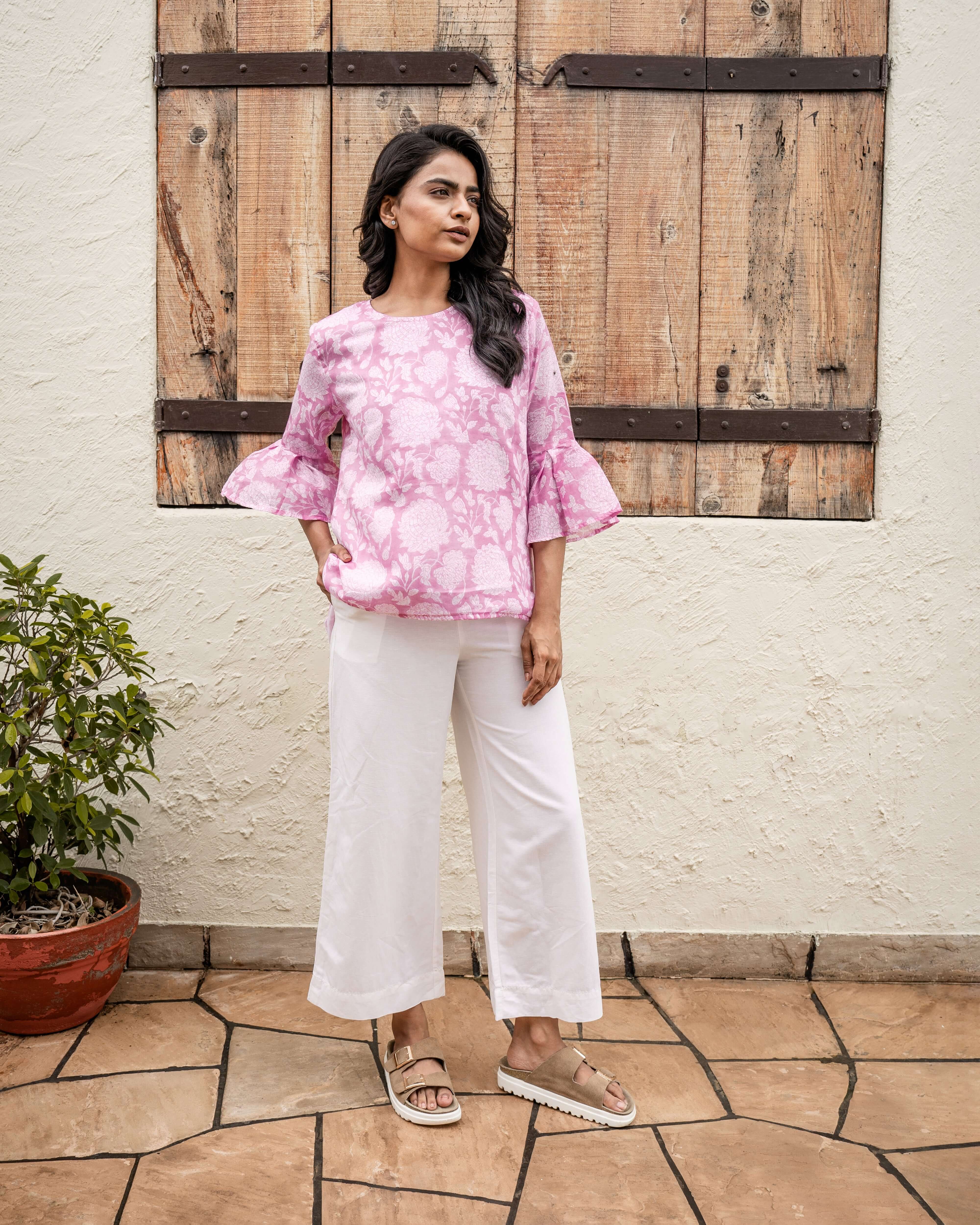 Elegant pink floral top with hand block print, flared cuffs, and soft cotton fabric, perfect for a relaxed yet stylish look.