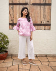 Elegant pink floral top with hand block print, flared cuffs, and soft cotton fabric, perfect for a relaxed yet stylish look.