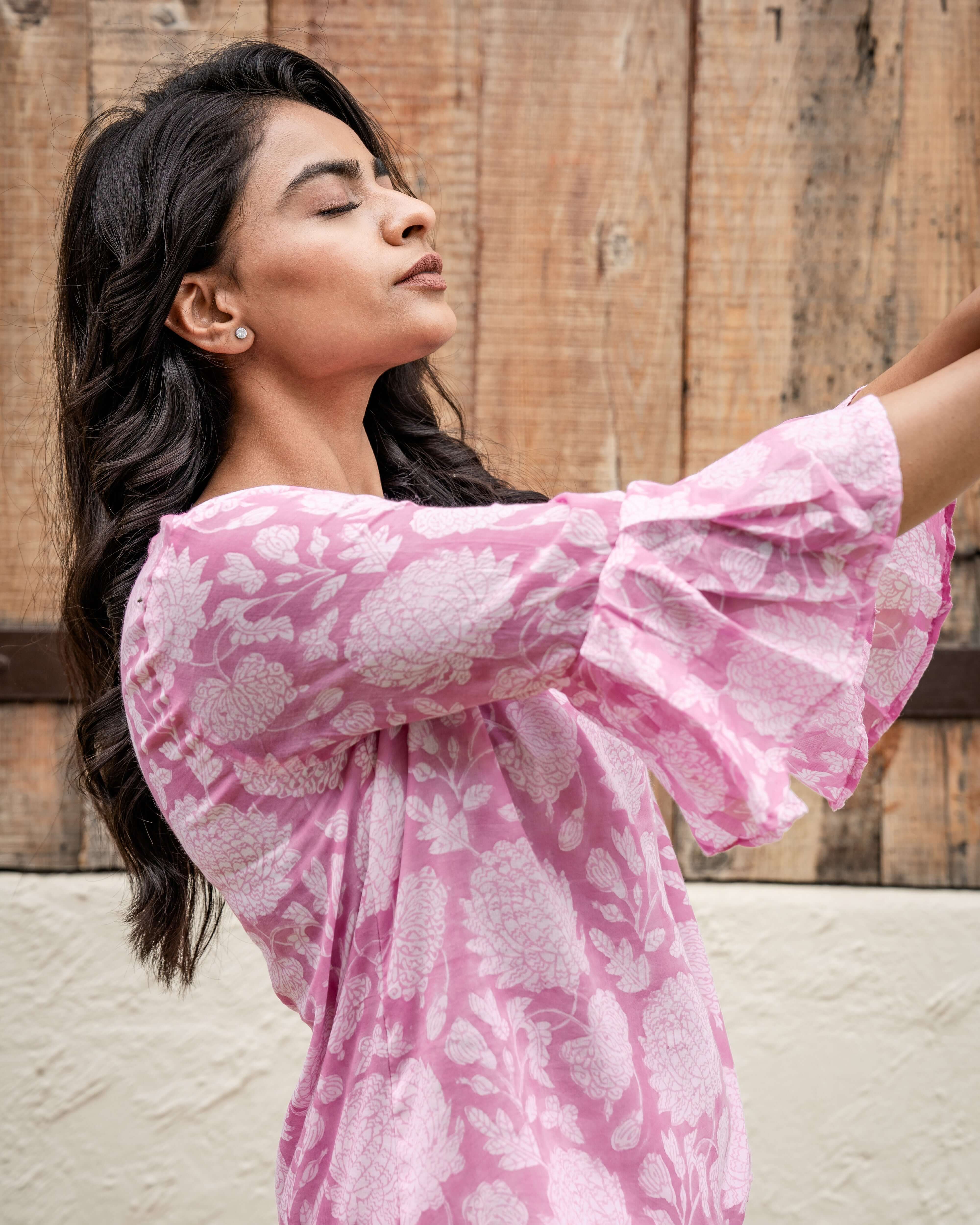 Beautiful pink floral cotton top with a relaxed fit, 3/4 flared sleeves, and vintage-inspired block print for a casual yet elegant style.