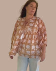 Comfortable brown cotton shirt with a colorful floral print, suitable for everyday outfits.