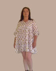 White and yellow cotton midi dress with a relaxed fit, ideal for casual outings and summer gatherings.